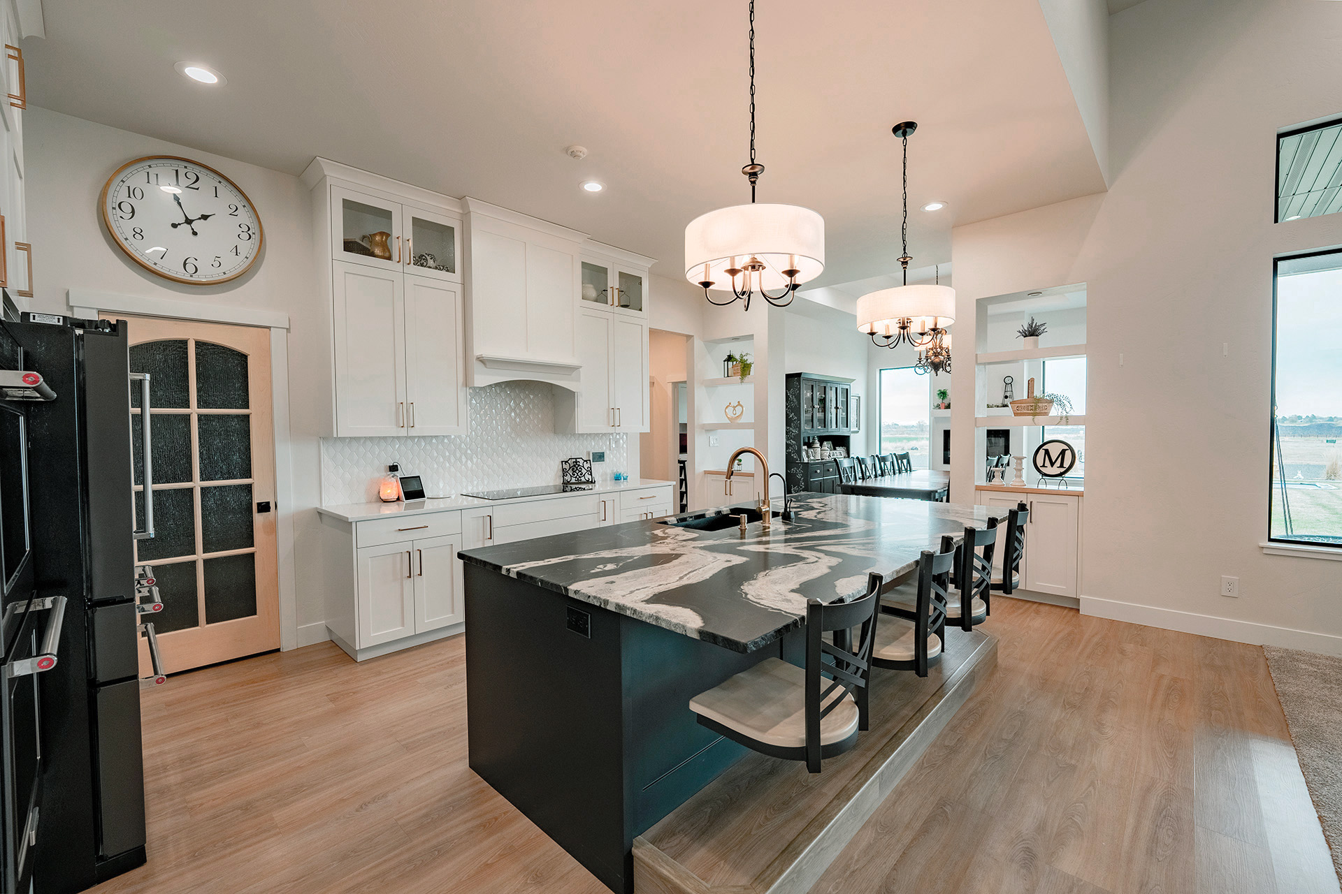 Beautiful kitchen with unique marble counters and swivel bar chairs
